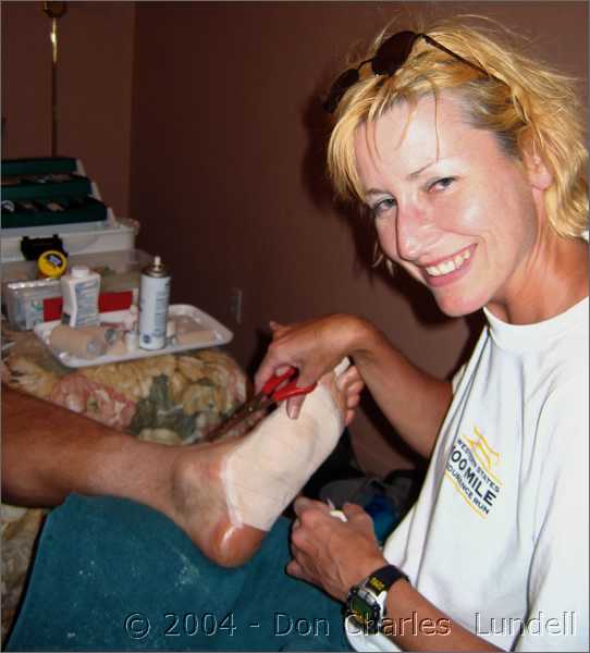 Gillian taping Steve's feet